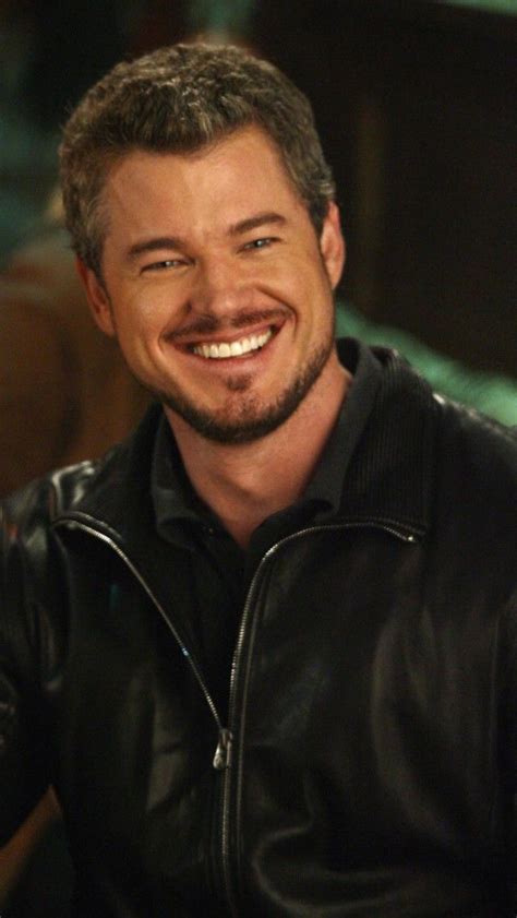 a smiling man wearing a black leather jacket