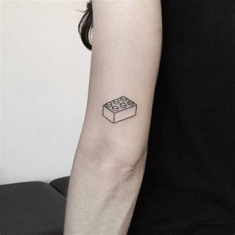 Lego brick tattoo on the left arm - Tattoogrid.net