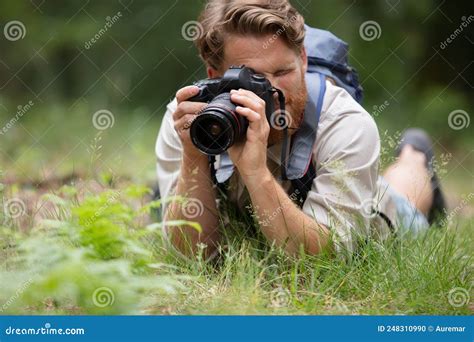 Photographer Lying Down Taking Nature Photo Stock Photo - Image of ...