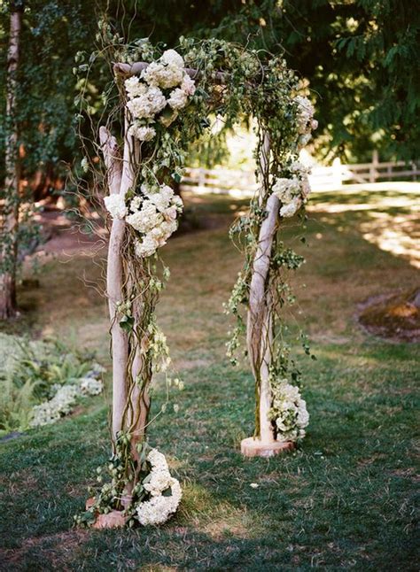 Picture Of wooden wedding arch decorated with white flowers