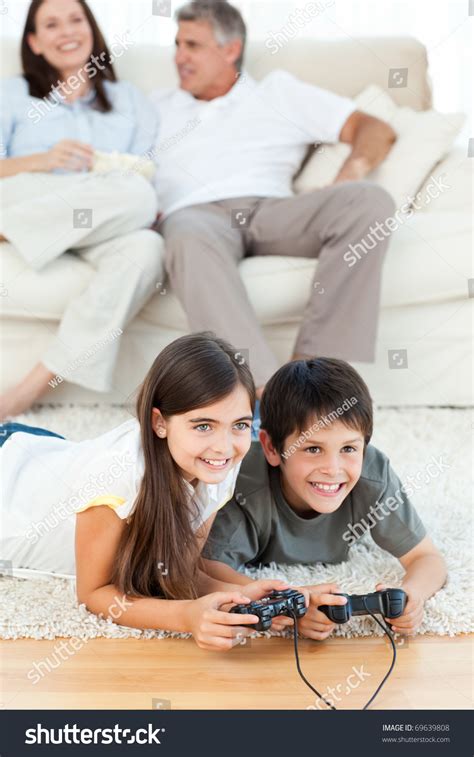 Children Playing Video Games While Parents Stock Photo 69639808 ...