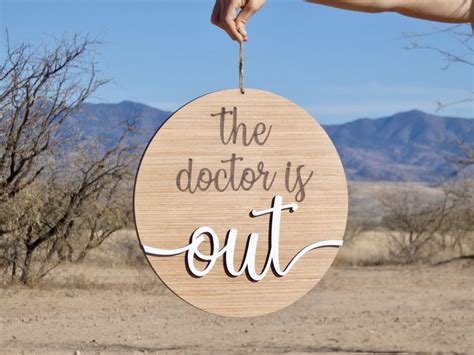 a wooden sign that says the doctor is out