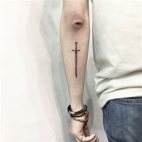 Little sword tattoo on the forearm - Tattoogrid.net