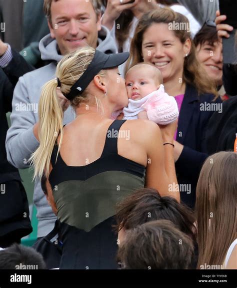 Russian Maria Sharapova kisses a baby while celebrating with her team ...