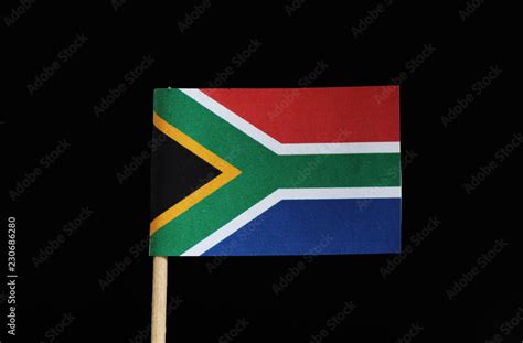 A national flag of South Africa on toothpick on black background. The ...