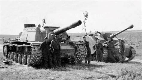 German soldiers and Stug III crew stands next to a Red Army captured ...