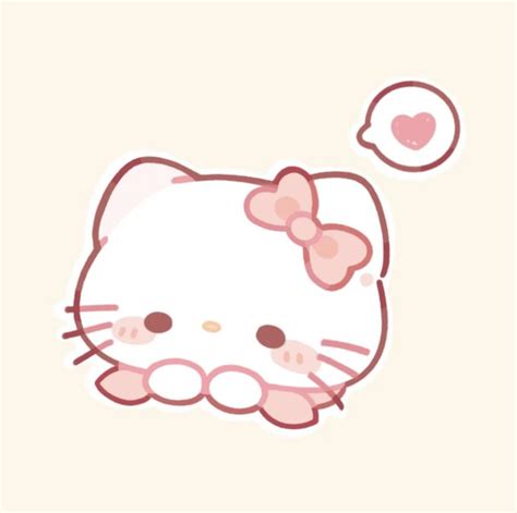 a hello kitty sticker sitting on top of a white wall next to a pink heart