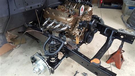 5.3L Vortec Engine painted gold & stainless headers sitting on custom ...