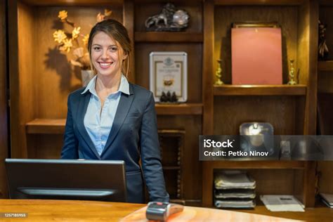 Hotel Receptionist Smiling At Camera Stock Photo - Download Image Now ...