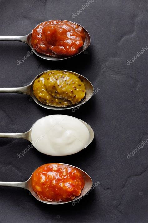 Different types of condiments on spoons — Stock Photo © Daxiao ...