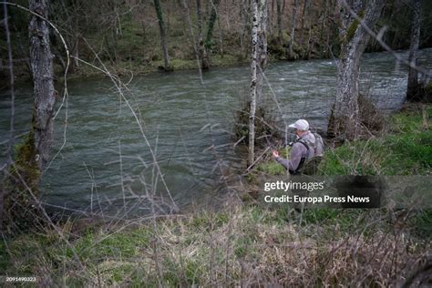 A man fishes in the Navia river, on 17 March, 2024 in Cervantes ...