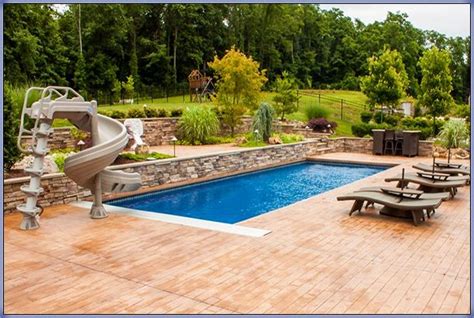 inground pool with paver deck, raised wall and 360 slide Pool Deck ...