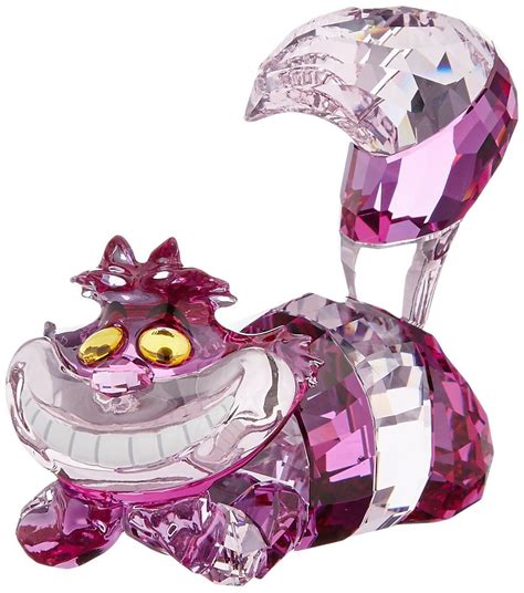 a pink glass figurine that looks like an animal with big eyes and large ...