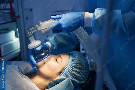 Anesthesia mask placed on the face of female patient Stock Photo ...