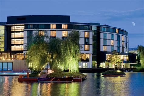 The Ritz-Carlton, Wolfsburg curves away from the lake into the evening ...