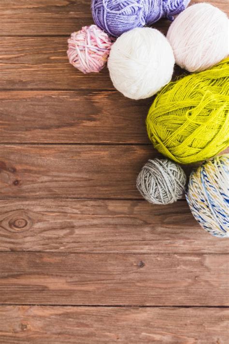 Free Photo | Multi colored ball of yarns on wooden background | Yarn ...