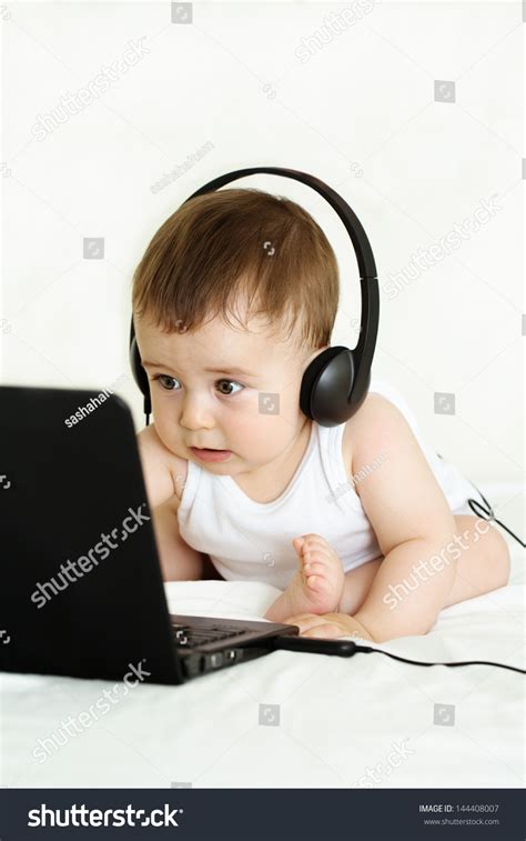 Funny Baby Typing And Watching Computer With Headset Stock Photo ...