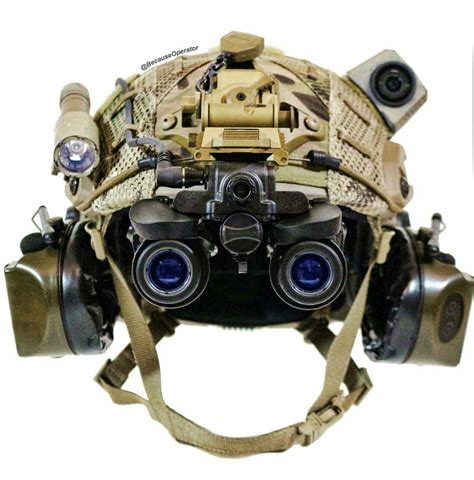 a helmet with binoculars attached to it's side and two cameras on the back