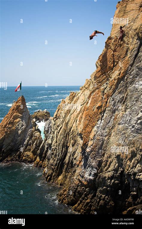 Cliff diver, a clavadista, diving off the cliffs at La Quebrada ...