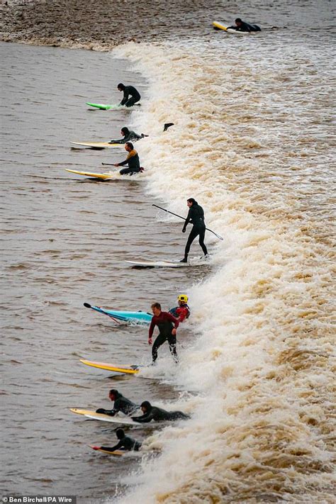 Moment huge line of surfers ride the five-star Severn Bore tidal wave ...