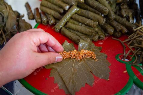 Premium Photo | Stuffed grape leaves. preparation of dolma from grape ...