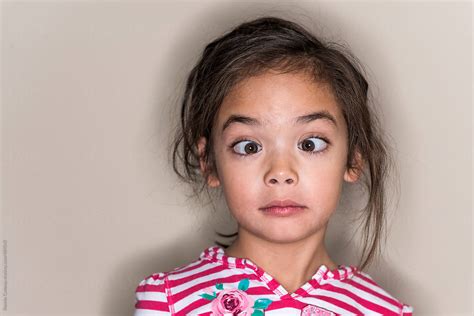 Cute Young Girl Making A Funny Face In A Field By Stocksy Contributor ...