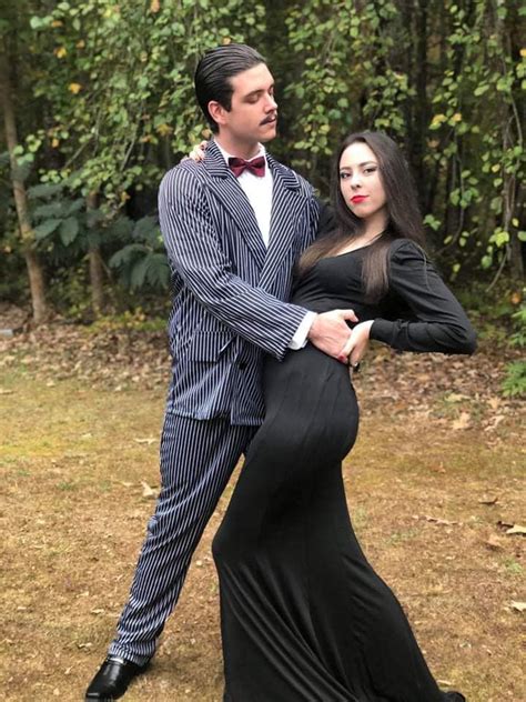 a man in a tuxedo poses with a pregnant woman