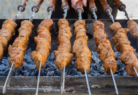 Premium Photo | Shish kebab is prepared on a charcoal grill