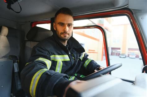 Premium Photo | Firefighter using radio set while driving fire truck