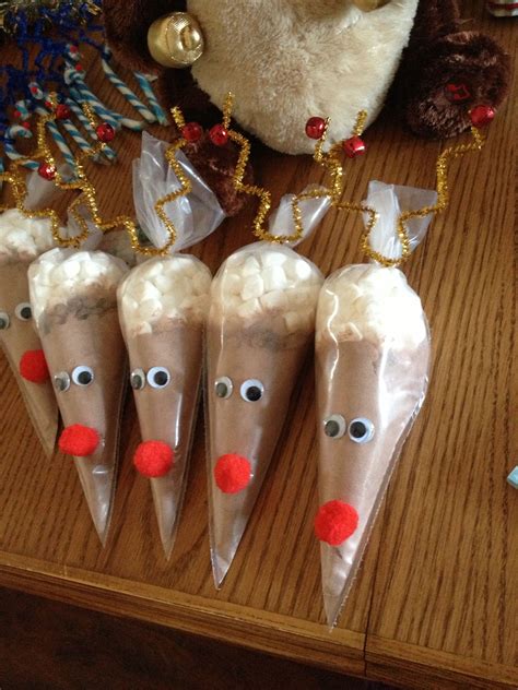 four reindeer cones with candy on them sitting on a table next to a ...