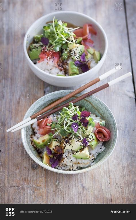 A sushi bowl with avocado, cress, soy sauce and pickled ginger stock ...