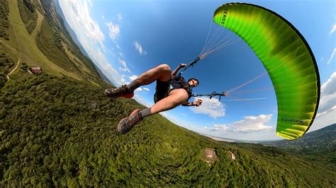 Man flying the paraglider on Behance