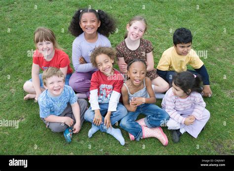 Multiracial group of children smiling Stock Photo - Alamy