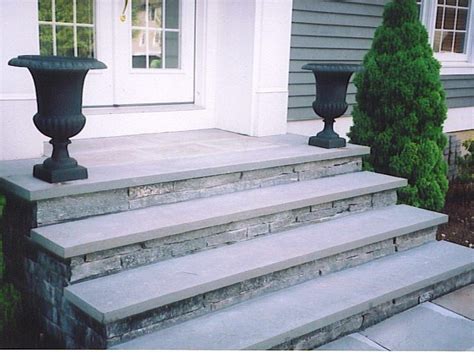 concrete stairs covered in stone veneer with bluestone treads ...