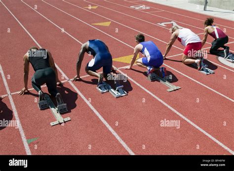 Male sprinters in starting blocks Stock Photo - Alamy