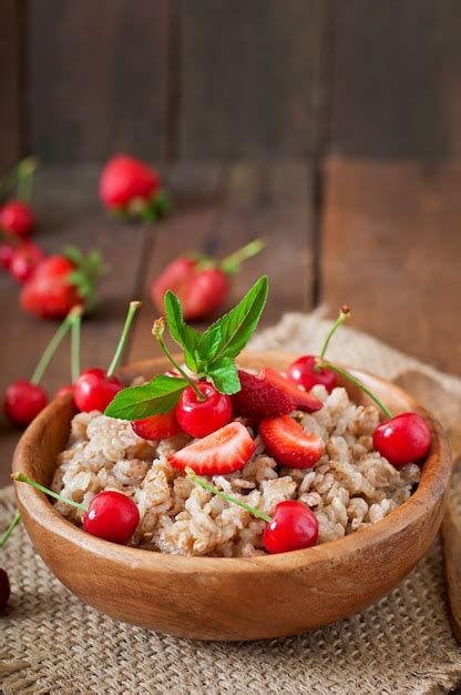 Free Photo | Oatmeal porridge with berries in a white bowl