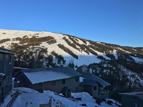 Premium Photo | Houses on a hillside in winter with snow and blue sky