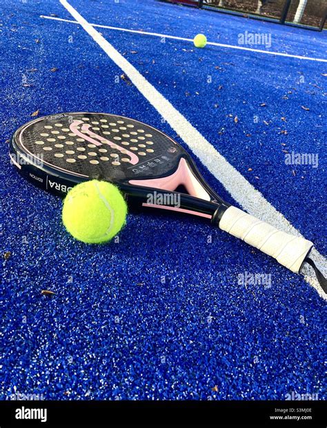 Padel racket with padel ball on the padel court Stock Photo - Alamy