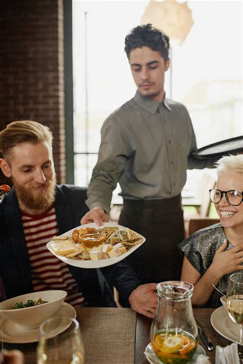 "Waiter Serving Dish To Customers" by Stocksy Contributor "Clique ...