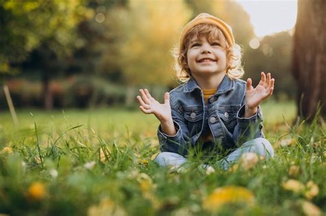 Free Photo | Cute boy sit on grass in park