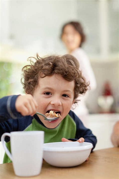 Boy eating breakfast in kitchen stock photo