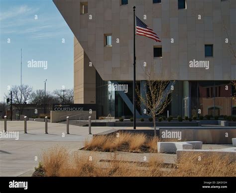 A view of a modern building of a Johnson County Courthouse and a waving ...