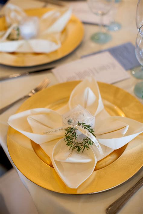 the table is set with gold plates and napkins