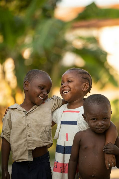 Happy African children embracing on street · Free Stock Photo