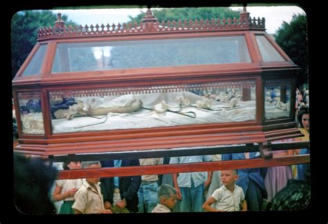 Glass coffin with shrouded body carried in procession | Flickr