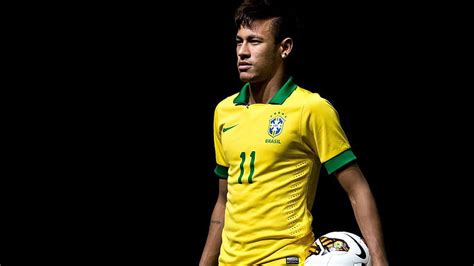 Neymar Is Holding Ball Left Side Standing In Black Background Wearing ...