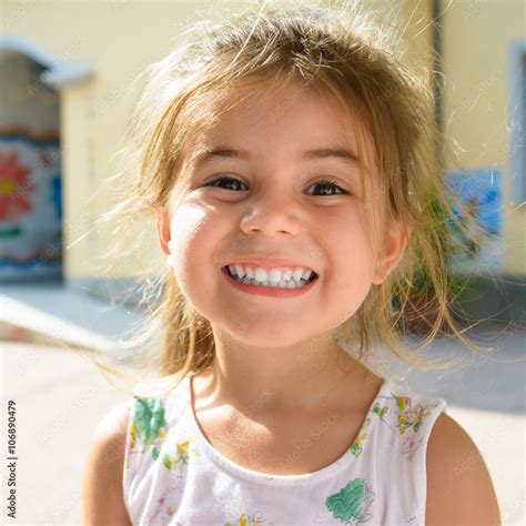 Cute and young little girl smiling Stock Photo | Adobe Stock