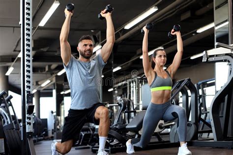 Attractive Sports People are Working Out with Dumbbells at Gym Stock ...