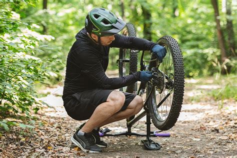 Young bicyclist fixing bike chain in | Stock Photos ~ Creative Market