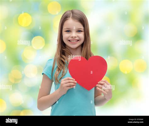 smiling little girl with red heart Stock Photo - Alamy